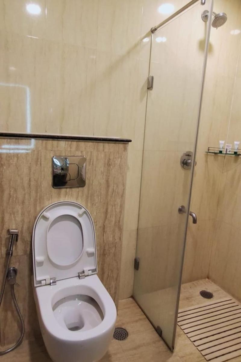 a bathroom with a toilet and a shower at Fortune Select Grand Ridge, Tirupati - Member ITC Hotels' Group in Tirupati