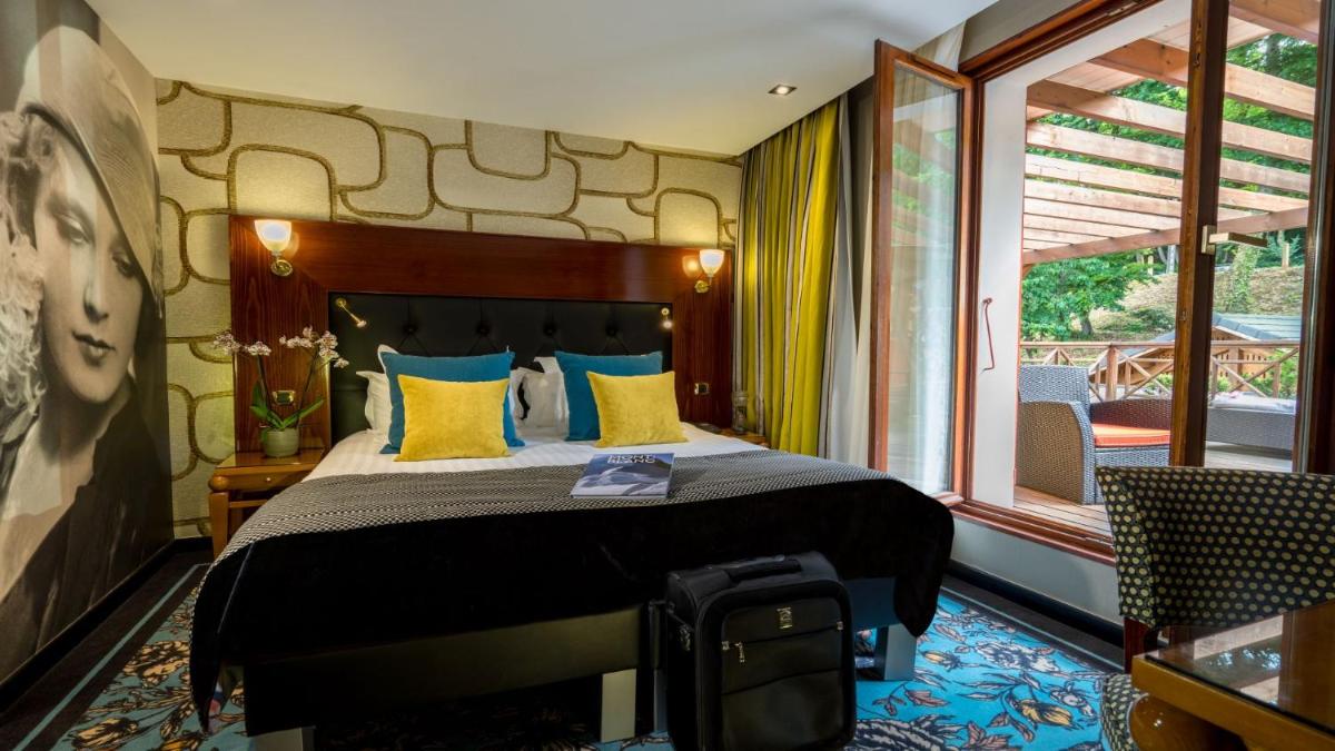 Un ou plusieurs lits dans un hébergement de l'établissement Les Trésoms Lake and Spa Resort