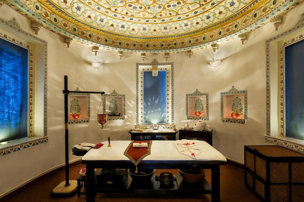 a room with a table and a ceiling at Shiv Niwas Palace by HRH Group of Hotels in Udaipur