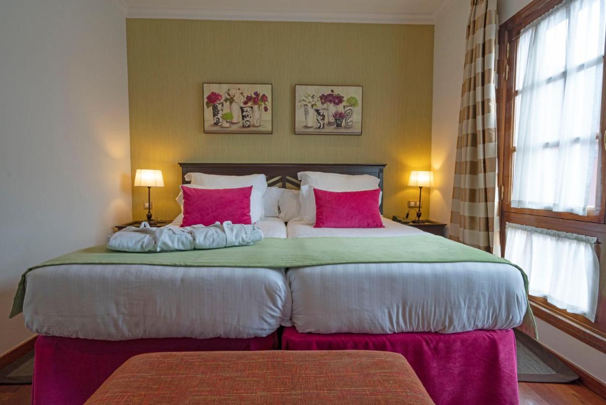 Cama o camas de una habitación en Laguna Nivaria Hotel & Spa