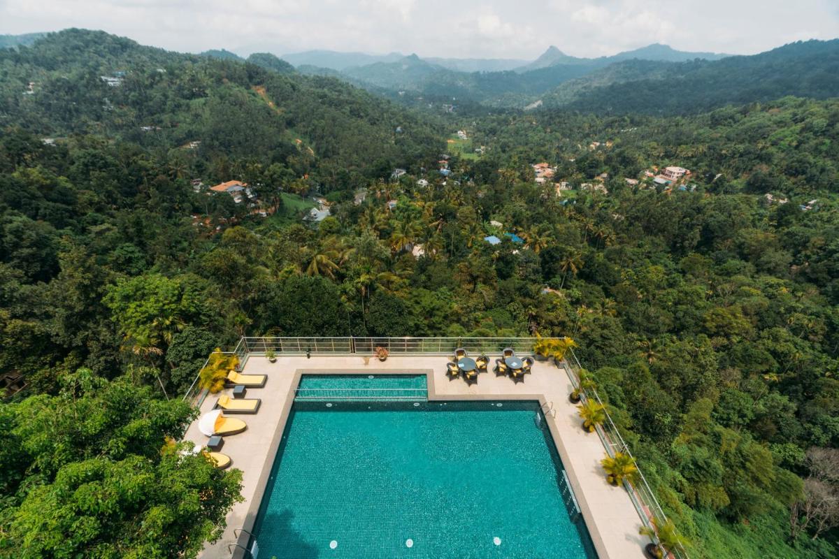 an overhead view of a swimming pool in the middle of a forest at The Panoramic Getaway in Munnar