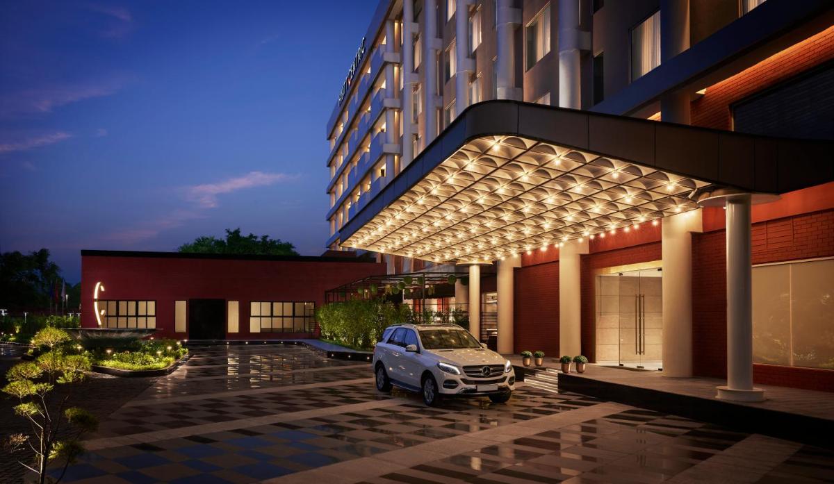 a car parked in front of a building with lights at Hyatt Centric Sector17 Chandigarh in Chandīgarh