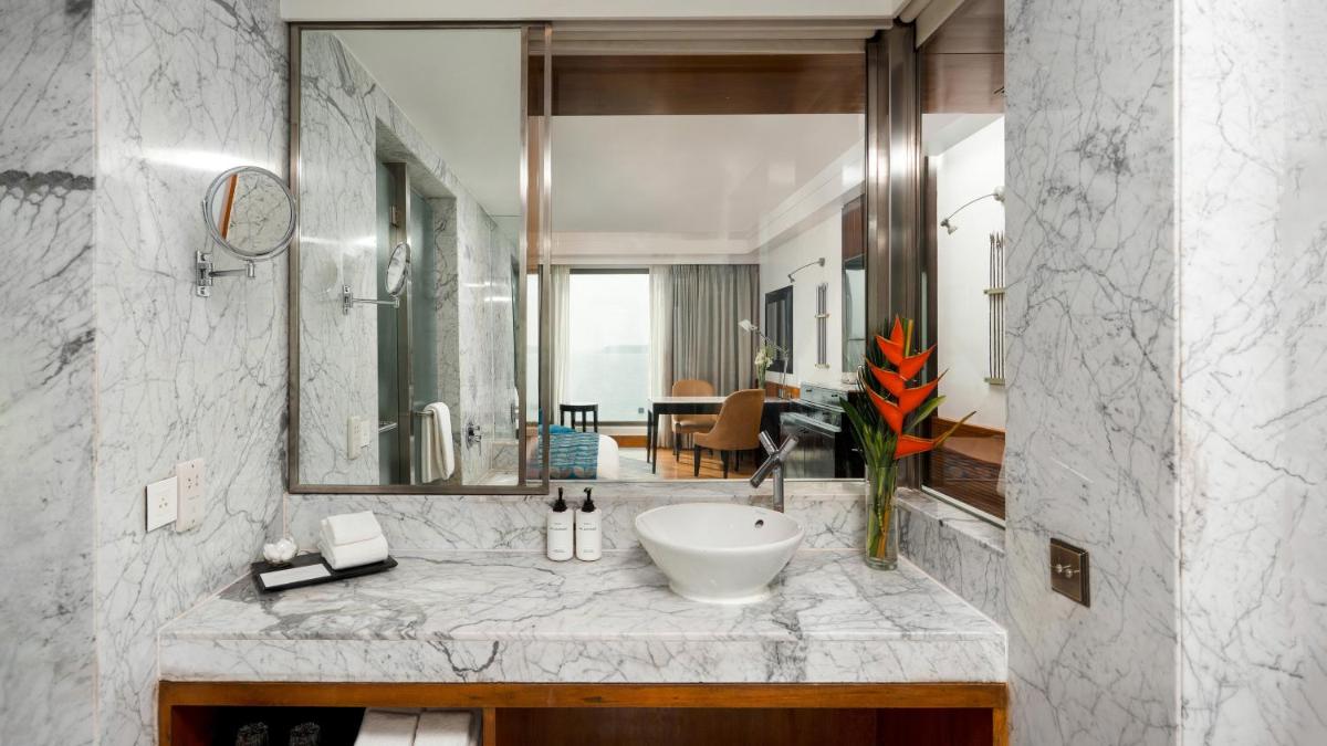 a bathroom with a sink and a large mirror at InterContinental Marine Drive Mumbai by IHG in Mumbai