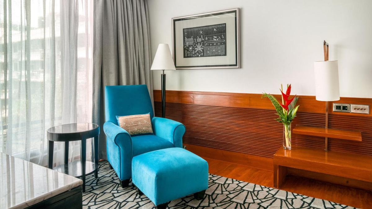 a room with a blue chair and a table at InterContinental Marine Drive Mumbai by IHG in Mumbai