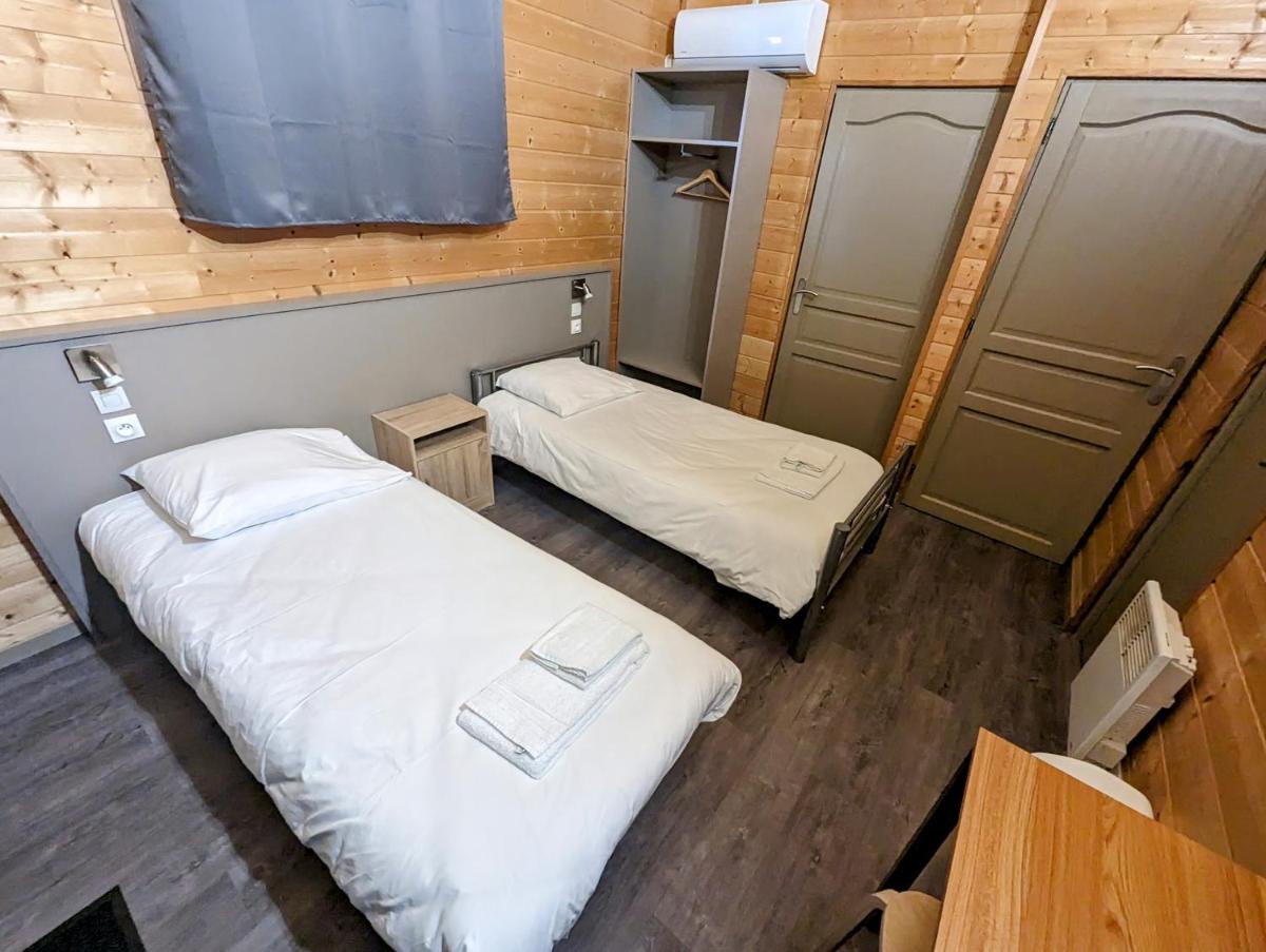 Un ou plusieurs lits dans un hébergement de l'établissement Lodge Hôtel & Spa Les Voiles du Grand Large
