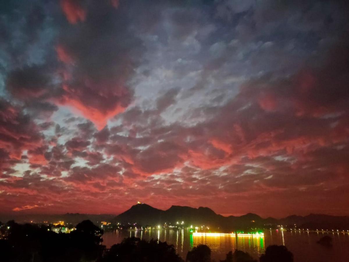 a heart in the sky over the water at night at The Lalit Laxmi Vilas Palace in Udaipur