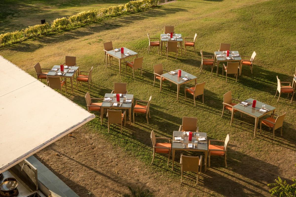 an overhead view of tables and chairs in a field at The Lalit Laxmi Vilas Palace in Udaipur