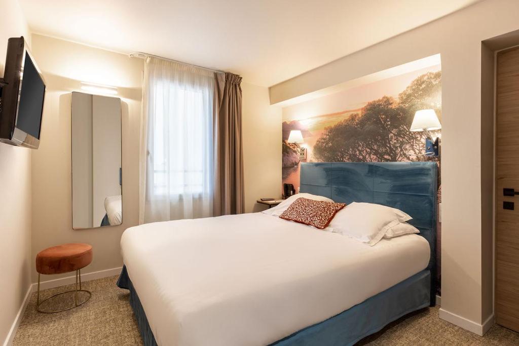 Un ou plusieurs lits dans un hébergement de l'établissement Best Western Hotel & SPA Coeur De Cassis