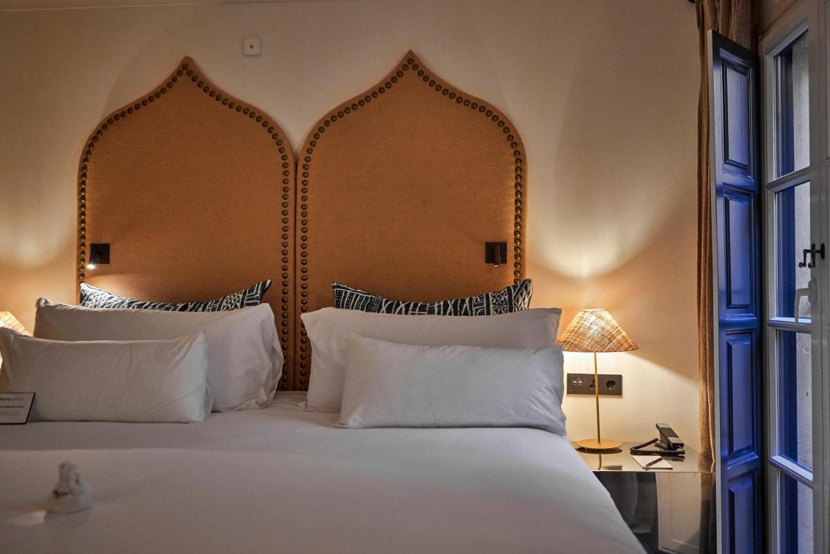 Cama o camas de una habitación en Puro Grand Hotel