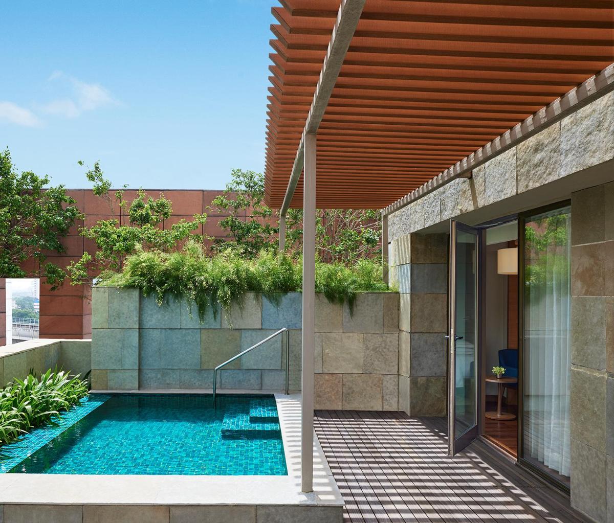 a house with a swimming pool next to a building at Taj City Centre New Town, Kolkata in Kolkata a house with a swimming pool next to a building at Taj City Centre New Town, Kolkata in Kolkata