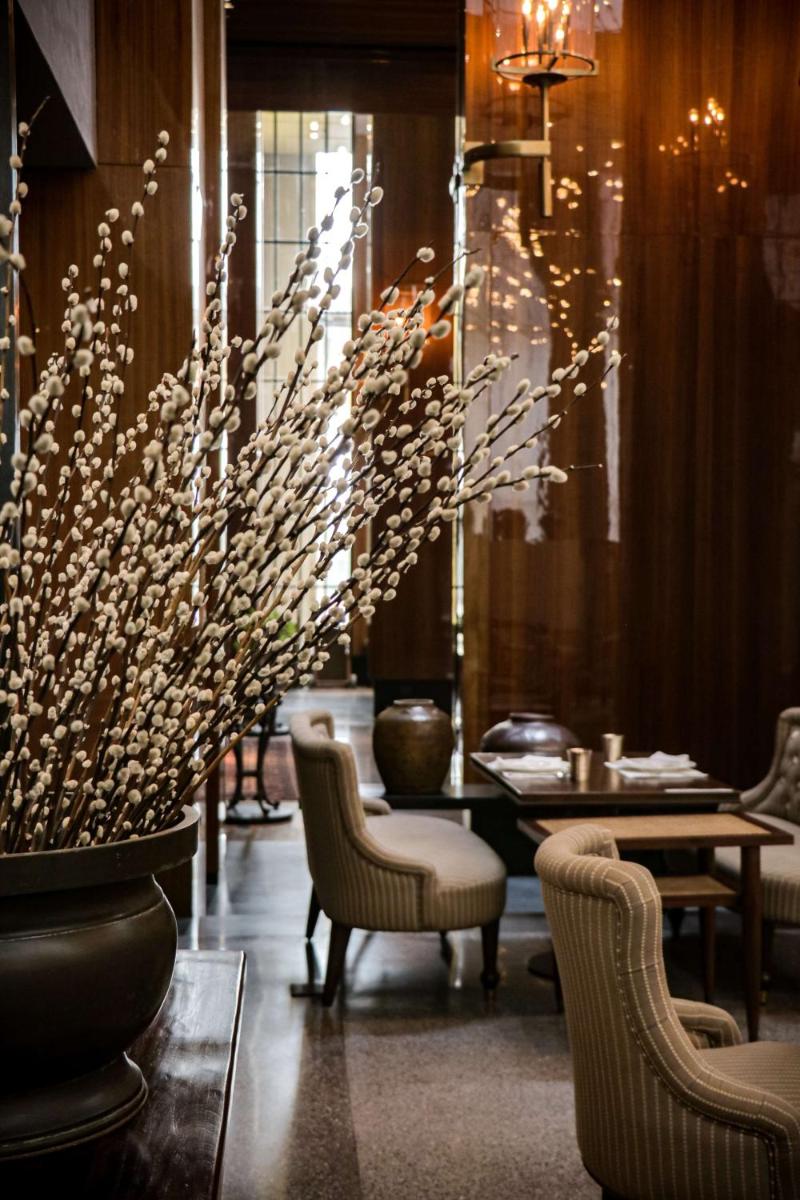 a restaurant with chairs and a table and flowers at Grand Hyatt Gurgaon in Gurgaon