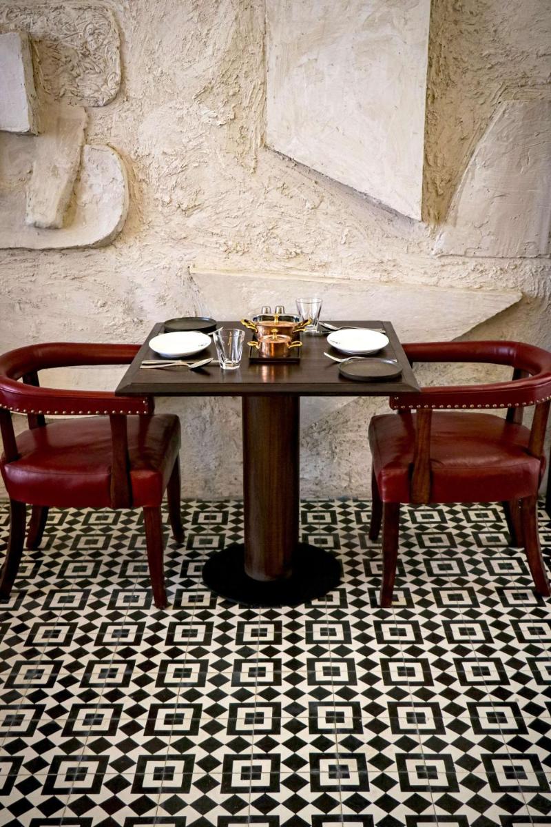 a table with two chairs and a table with glasses at Grand Hyatt Gurgaon in Gurgaon