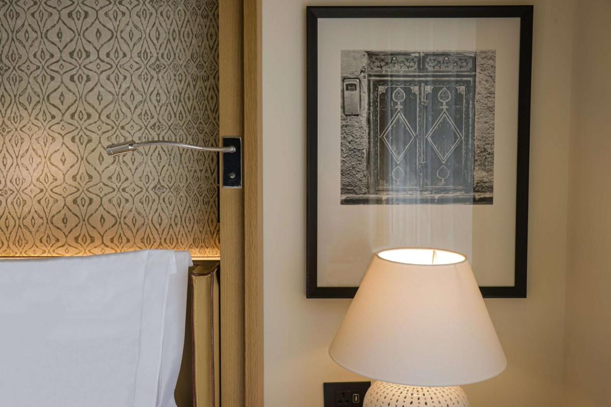 a lamp in a room with a picture of a door at Grand Hyatt Gurgaon in Gurgaon