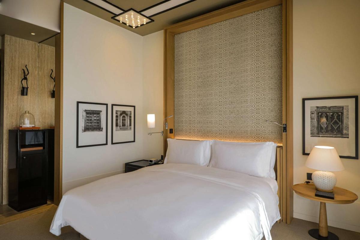 a bedroom with a large white bed and a window at Grand Hyatt Gurgaon in Gurgaon