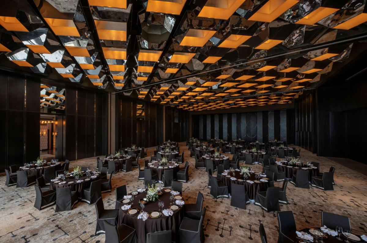 a banquet hall with tables and chairs in a room at Grand Hyatt Gurgaon in Gurgaon