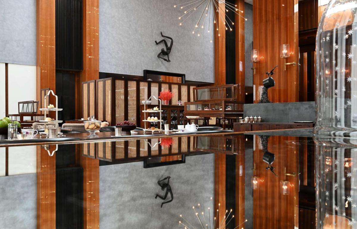 a dining room with a table and a bar at Grand Hyatt Gurgaon in Gurgaon