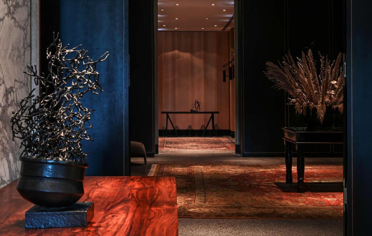 a hallway with a vase on a table in a room at Grand Hyatt Gurgaon in Gurgaon