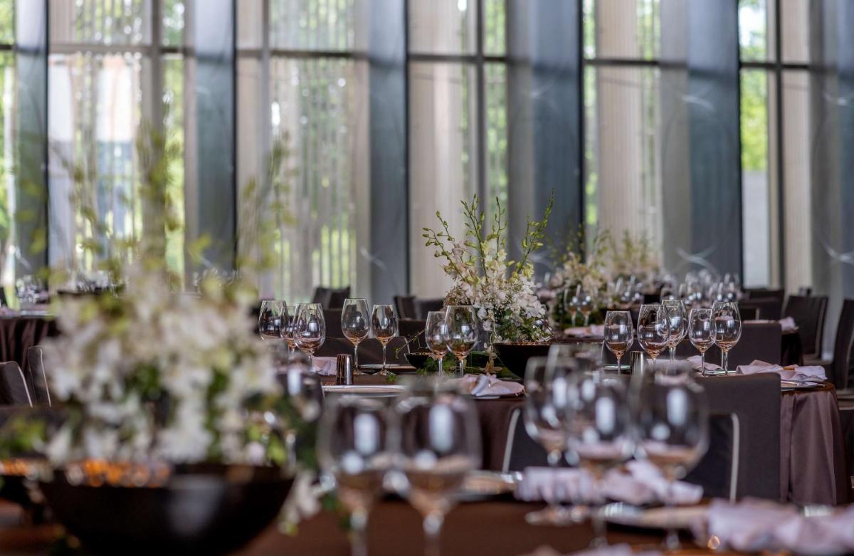 a set of tables with wine glasses on them at Grand Hyatt Gurgaon in Gurgaon