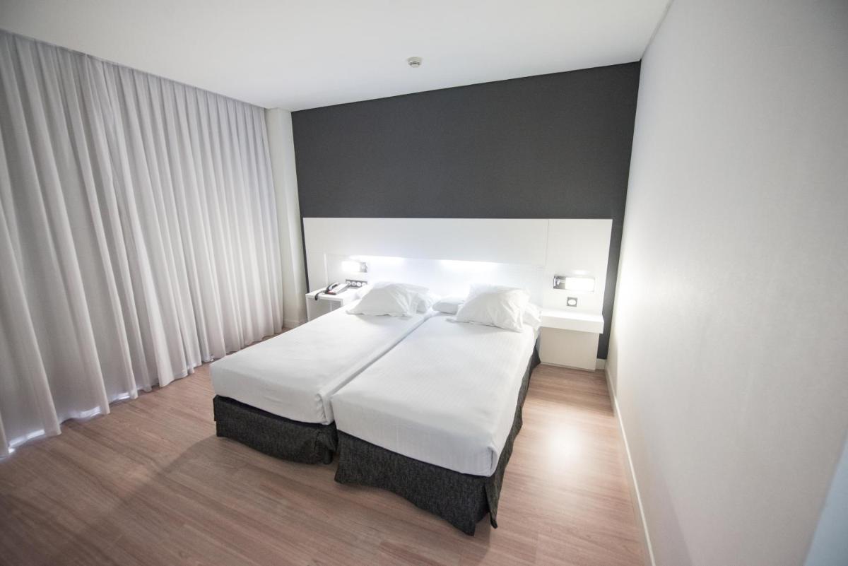 Cama o camas de una habitación en Axor Feria
