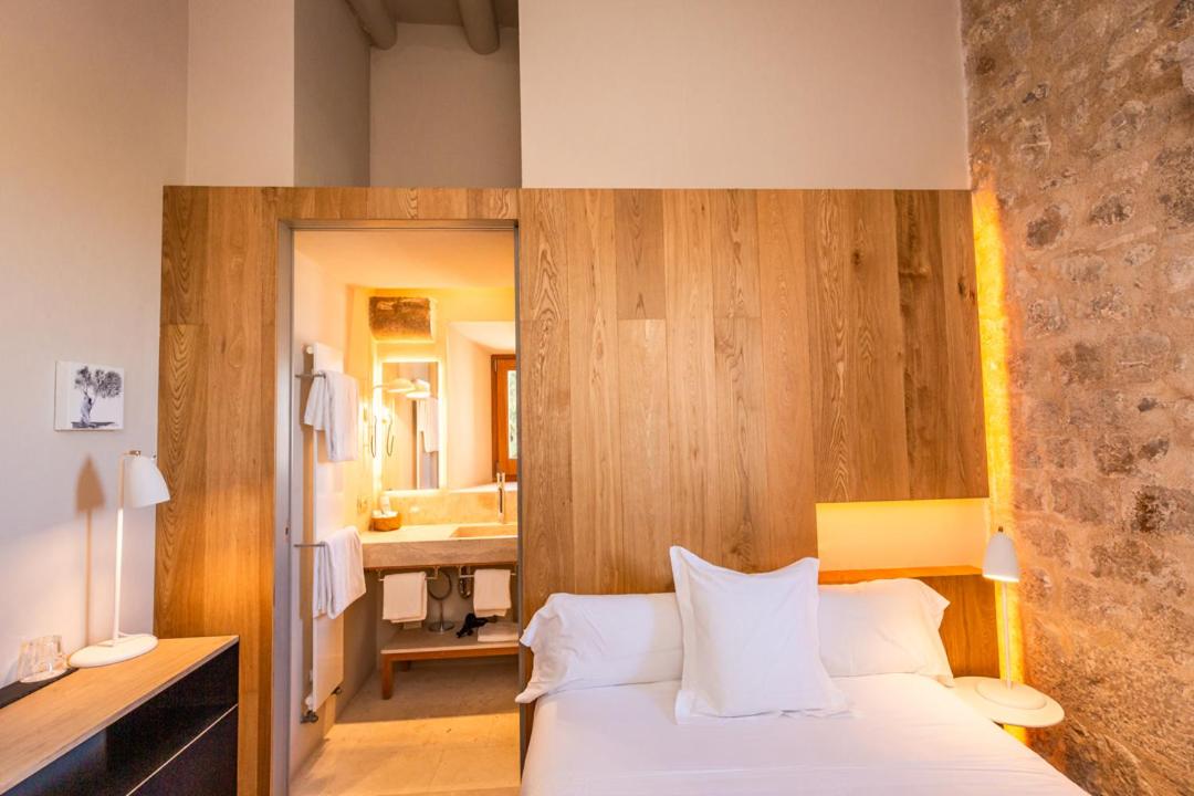 Cama o camas de una habitación en Hotel Mas Bosch 1526