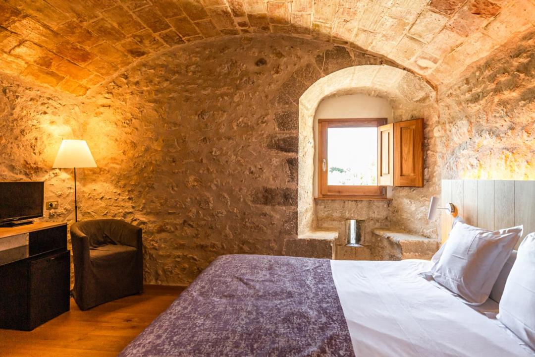 Cama o camas de una habitación en Hotel Mas Bosch 1526