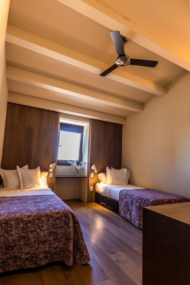 Cama o camas de una habitación en Hotel Mas Bosch 1526