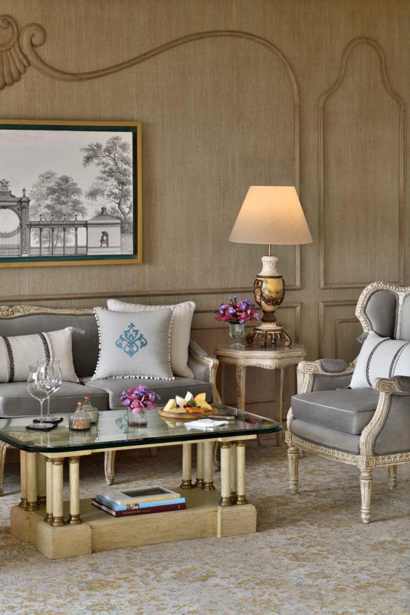 a living room with a couch and a table and chairs at Taj Mahal, New Delhi in New Delhi