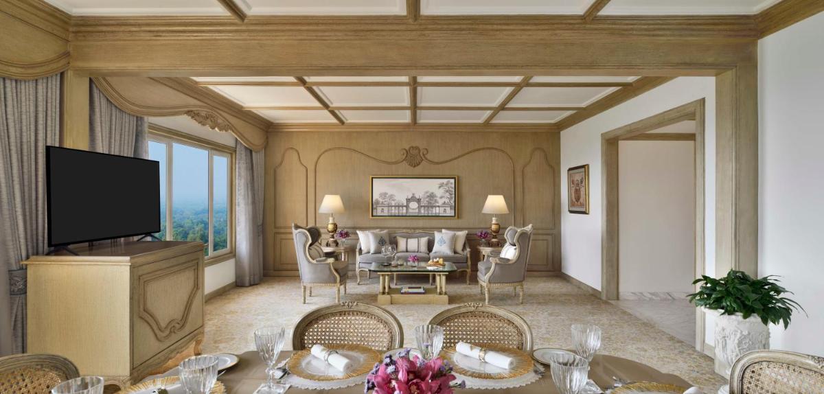 a living room with a television and a dining room at Taj Mahal, New Delhi in New Delhi