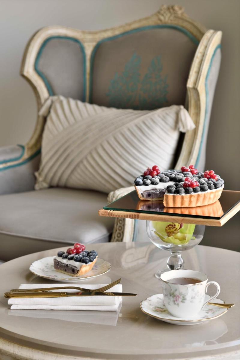 a table with two plates of desserts and a cup of coffee at Taj Mahal, New Delhi in New Delhi