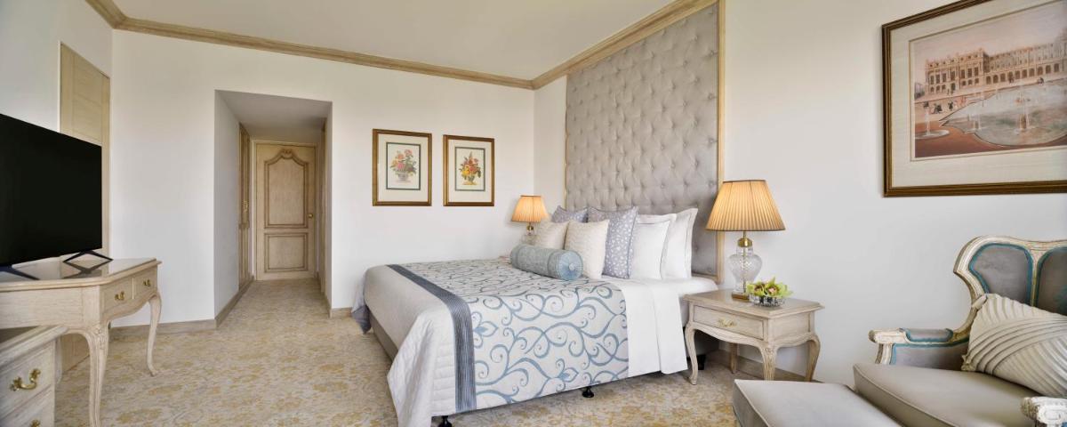 a hotel room with a bed and a couch at Taj Mahal, New Delhi in New Delhi