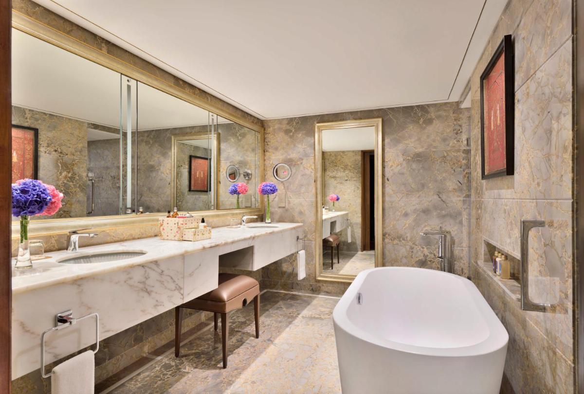 a bathroom with a tub and a sink and a toilet at Taj Mahal, New Delhi in New Delhi