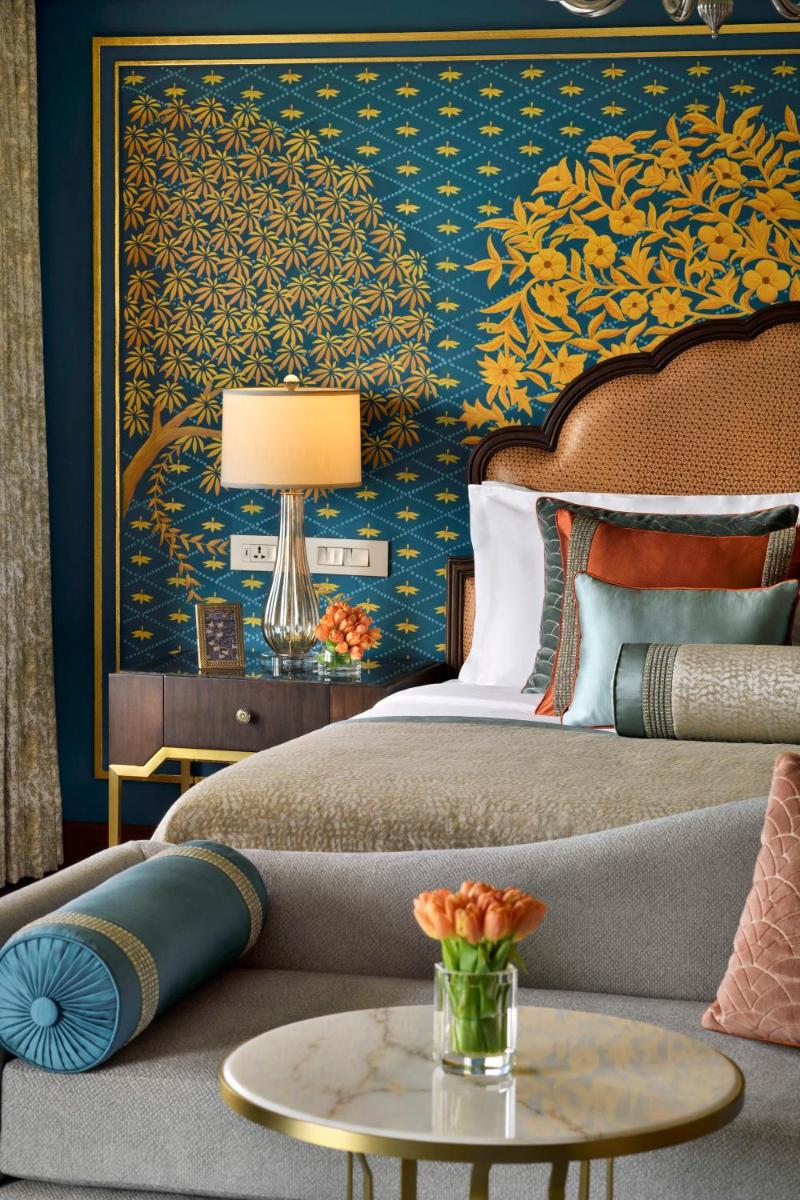 a bedroom with a bed and a couch and a table at Taj Mahal, New Delhi in New Delhi