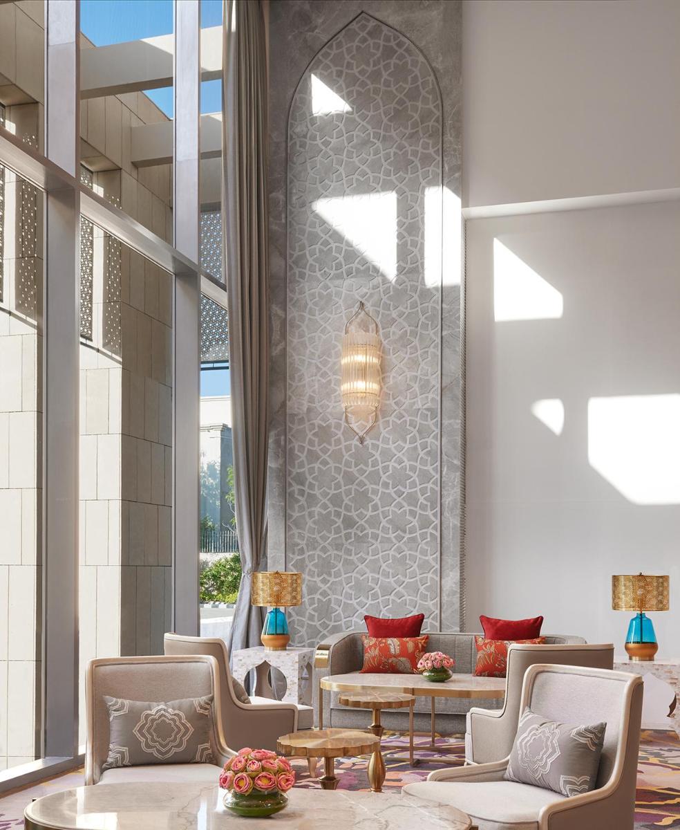 a lobby of a hotel with chairs and tables at Taj Amer, Jaipur in Jaipur
