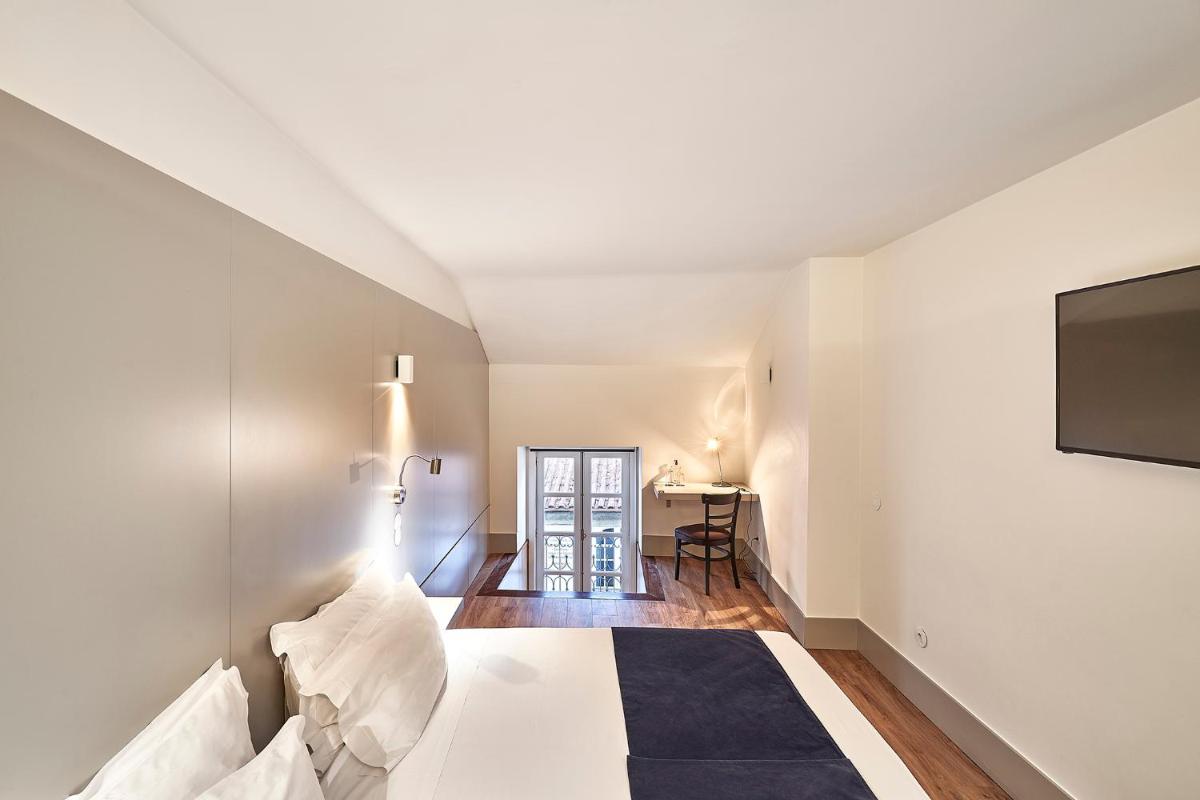 Uma cama ou camas num quarto em Ribeira Collection Hotel by Piamonte Hotels