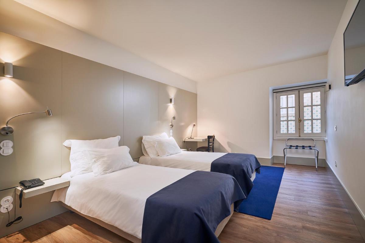 Uma cama ou camas num quarto em Ribeira Collection Hotel by Piamonte Hotels