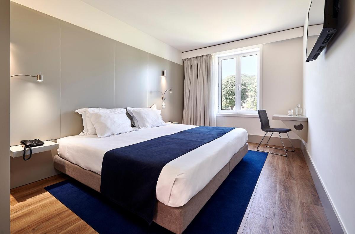 Uma cama ou camas num quarto em Ribeira Collection Hotel by Piamonte Hotels