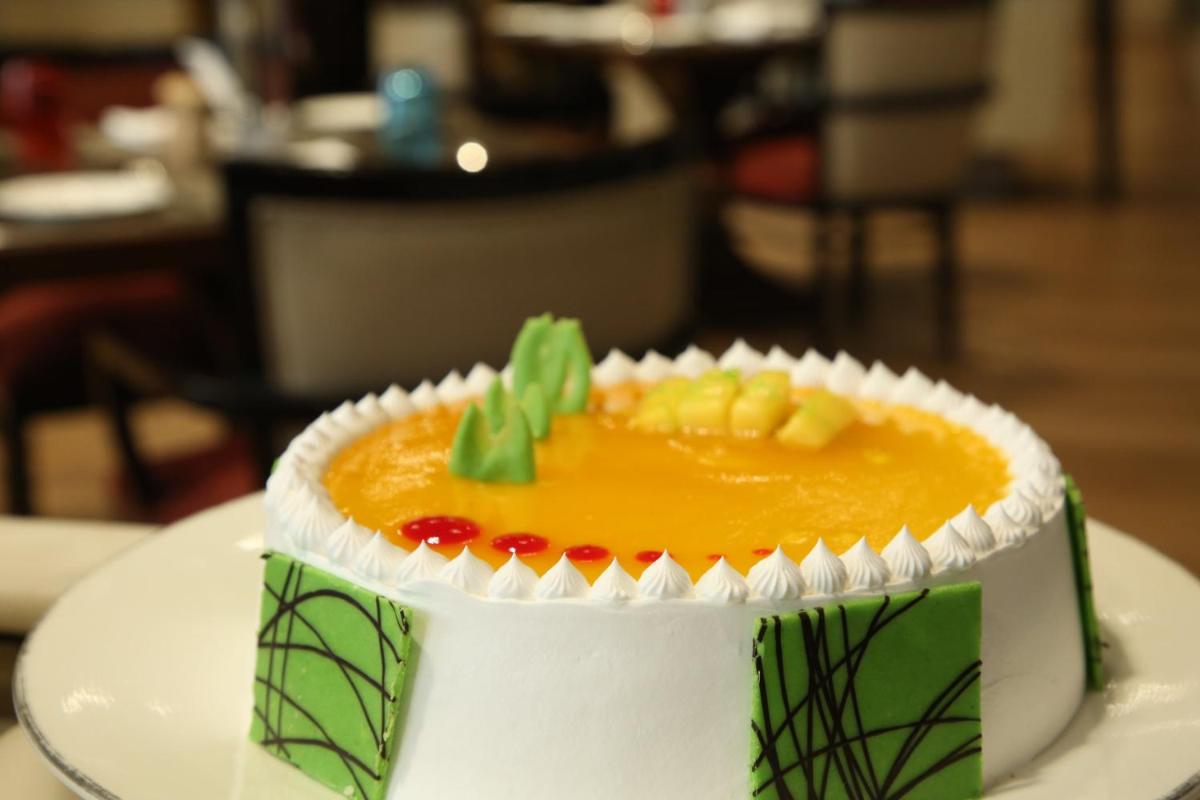 a cake sitting on top of a white plate at Crowne Plaza New Delhi Mayur Vihar Noida by IHG in New Delhi