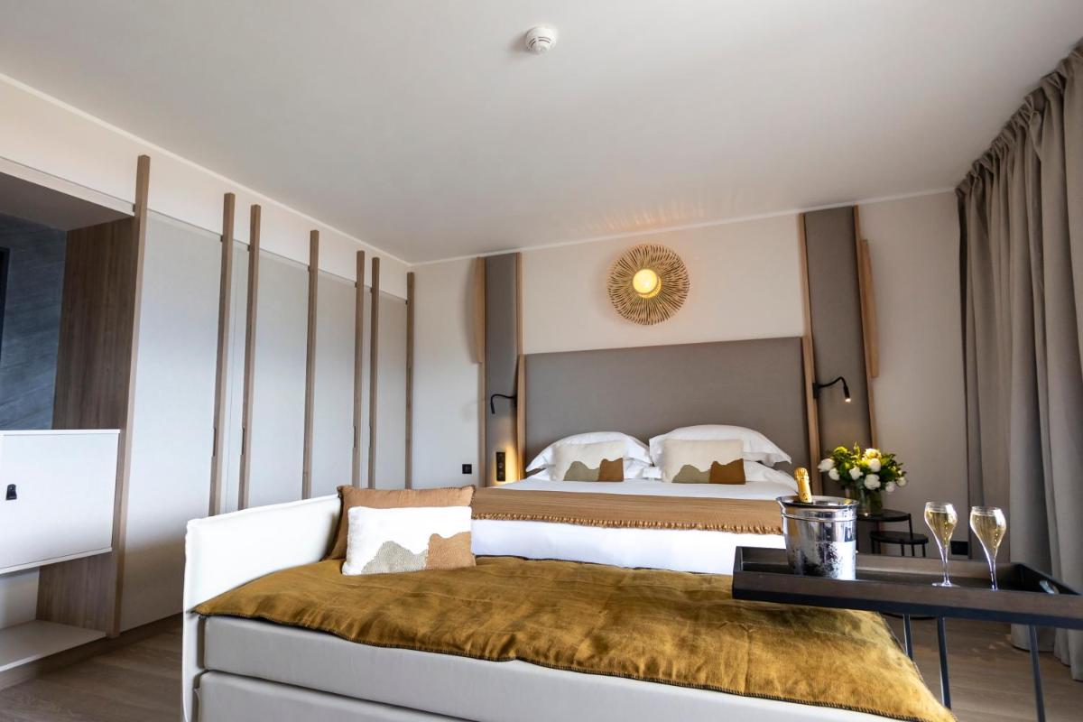 Un ou plusieurs lits dans un hébergement de l'établissement Hotel L'Acquale