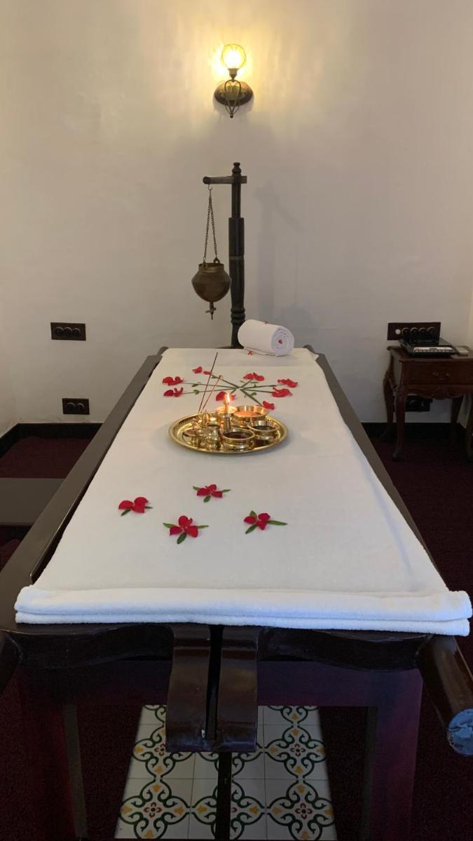 a table with candles on top of a table at Forte Kochi in Cochin