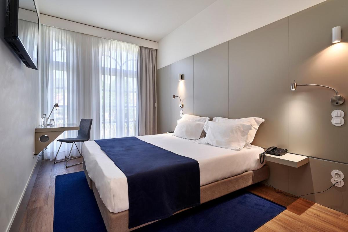 Uma cama ou camas num quarto em Ribeira Collection Hotel by Piamonte Hotels