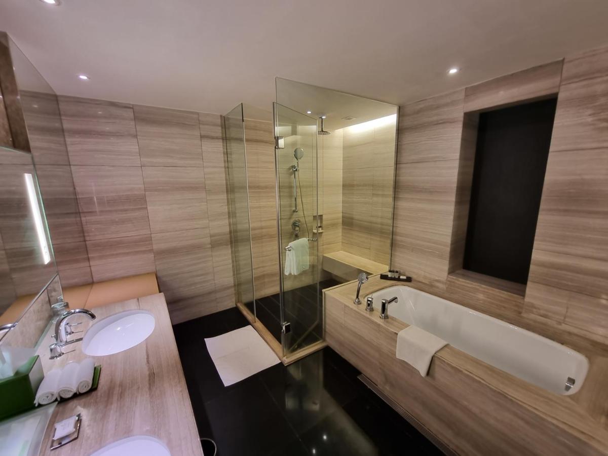 a bathroom with a tub and a sink and a shower at Holiday Inn New Delhi Aerocity by IHG in New Delhi