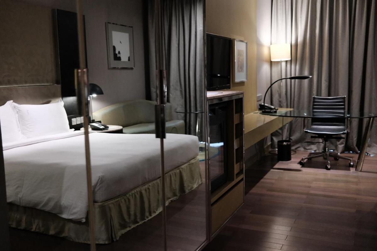 a hotel room with a bed and a desk with a computer at Holiday Inn New Delhi Aerocity by IHG in New Delhi