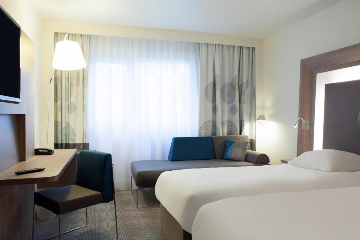 Un ou plusieurs lits dans un hébergement de l'établissement Novotel Fontainebleau Ury