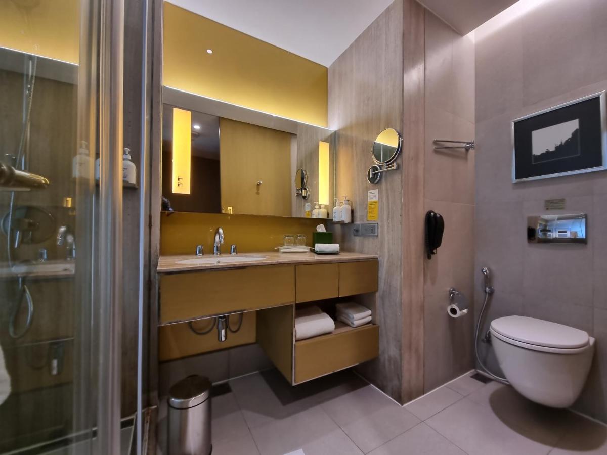 a bathroom with a sink and a toilet and a shower at Holiday Inn New Delhi Aerocity by IHG in New Delhi