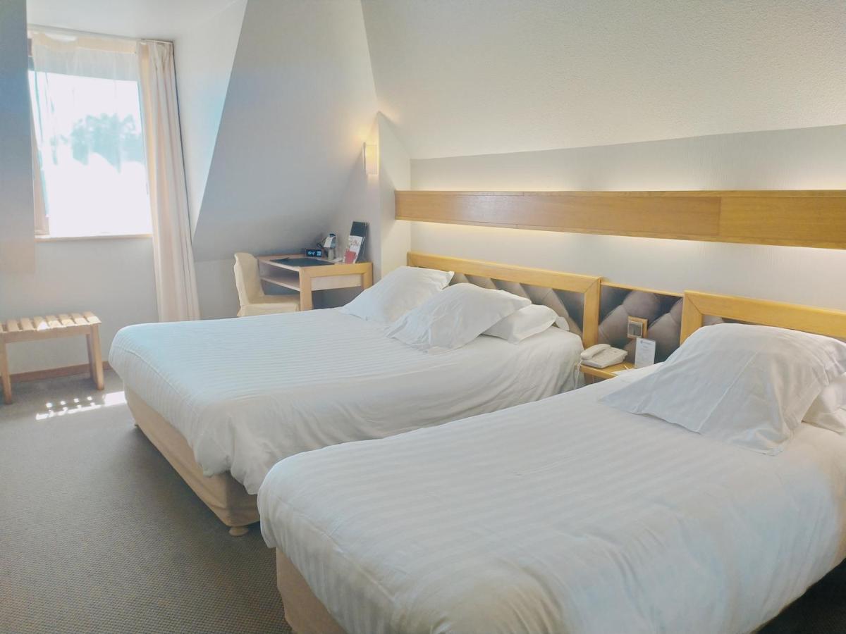 Un ou plusieurs lits dans un hébergement de l'établissement Best Western Le Relais de Laguiole Hôtel & Spa