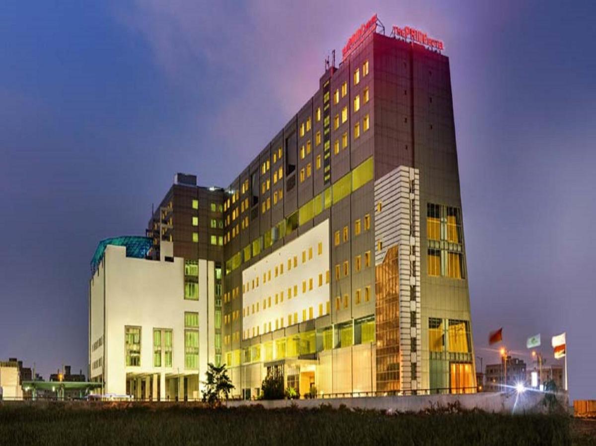 a tall building with a red at Pride Plaza Hotel, Kolkata in Kolkata