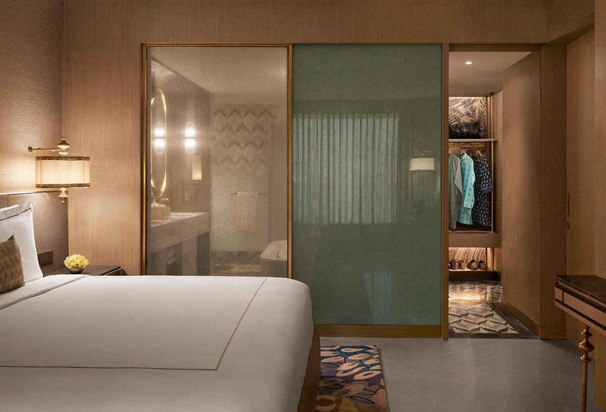 a bedroom with a bed and a walk in closet at Taj Amer, Jaipur in Jaipur