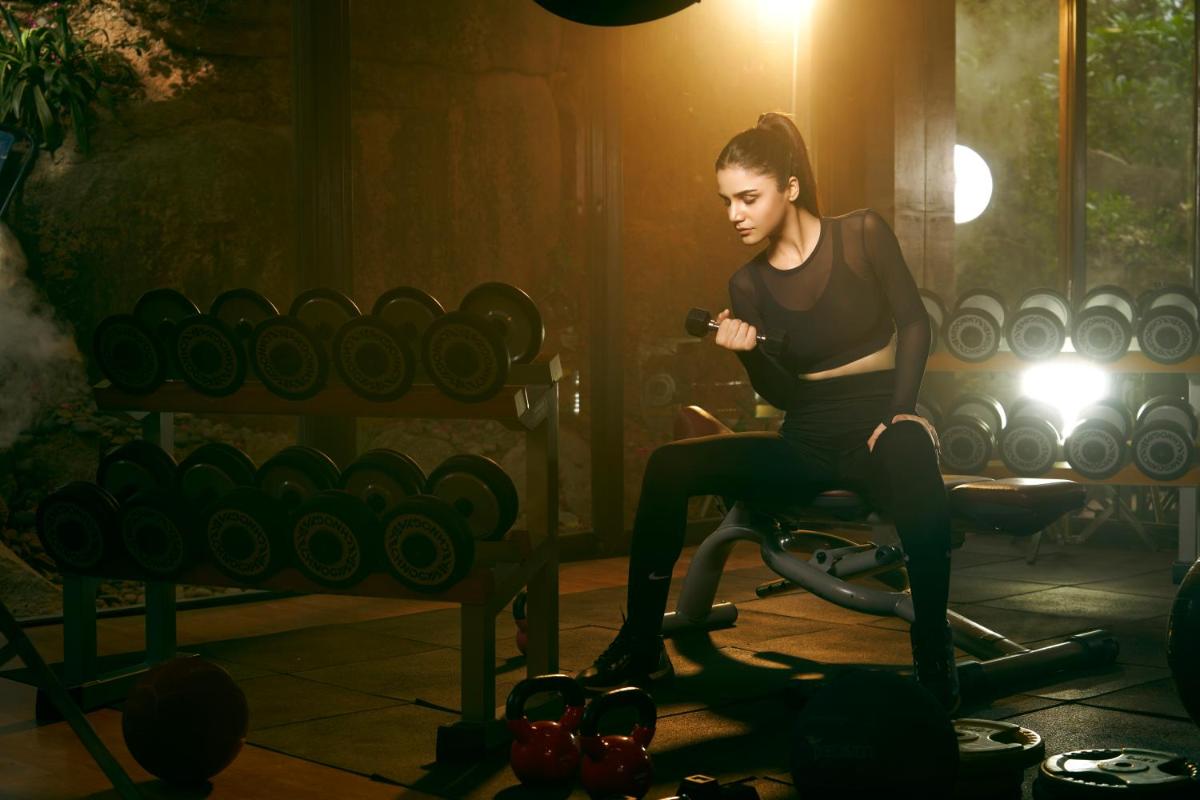 a woman sitting on a exercise bike in a gym at Hyatt Hyderabad Gachibowli in Hyderabad