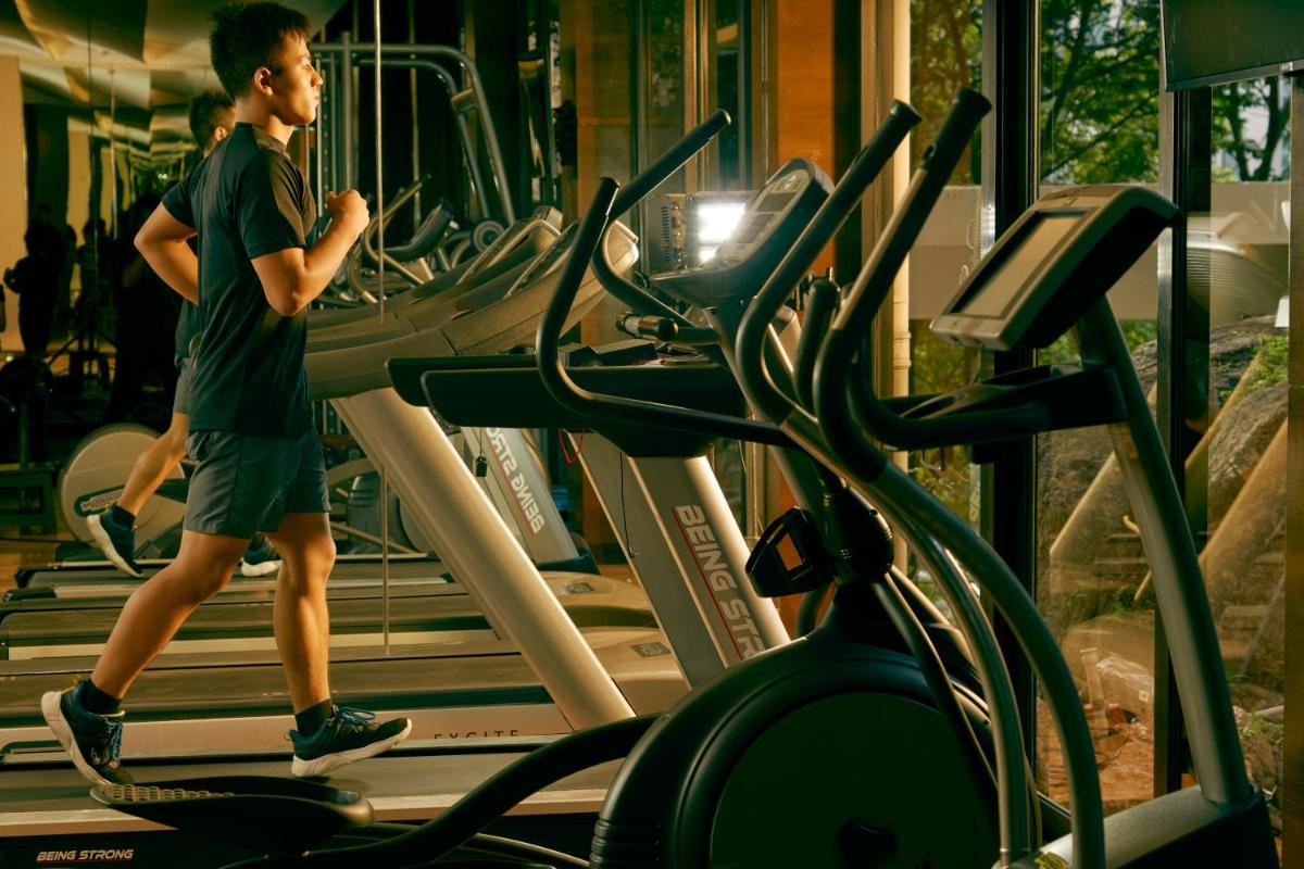 a man running on a treadmill in a gym at Hyatt Hyderabad Gachibowli in Hyderabad
