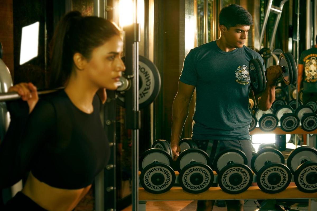 a man and a woman in a gym with weights at Hyatt Hyderabad Gachibowli in Hyderabad